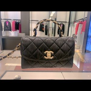 Chanel flapbag with handle black with gold hardware. Limited addition 21S